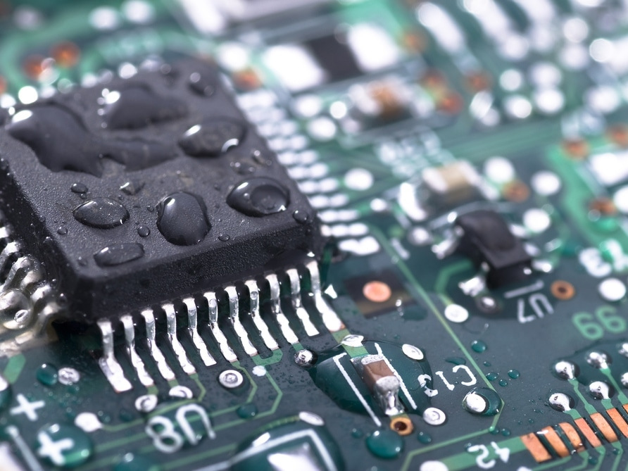 A circuit board with water droplets on it